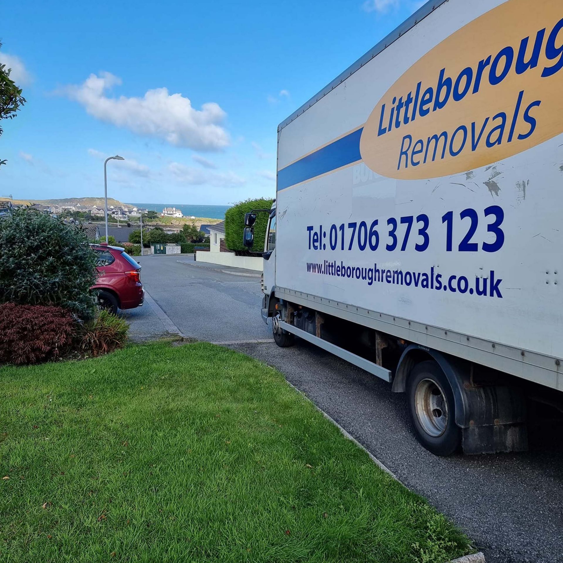 Littleborough Removals van parked on kerb on coast